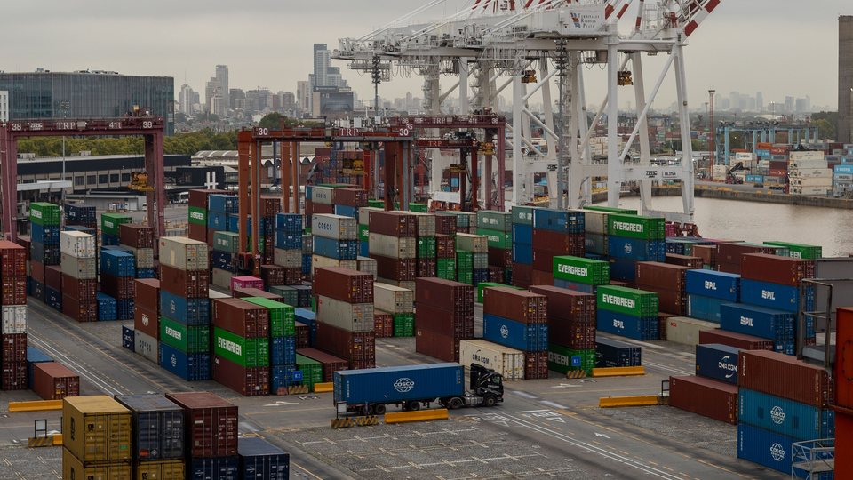Container port with cranes and stacked cargo containers