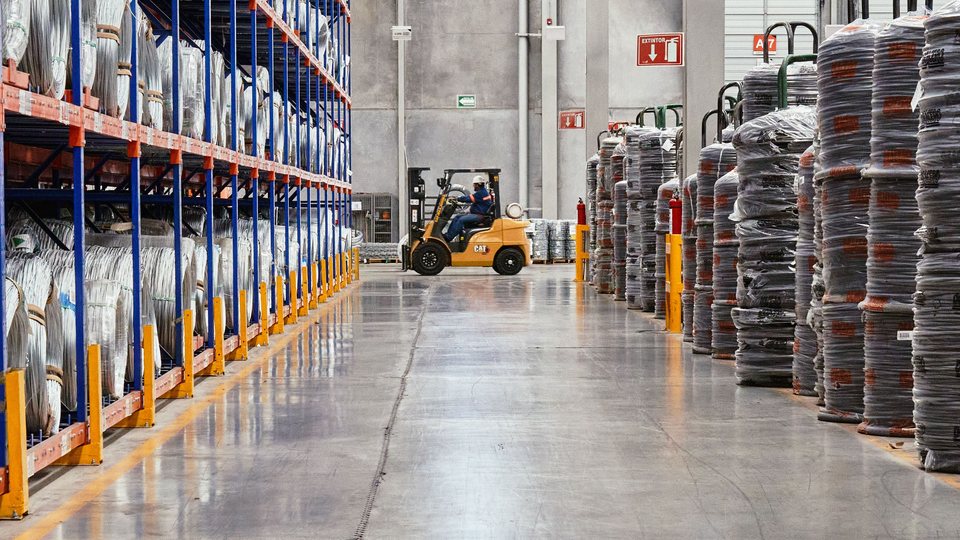 Warehouse aisle with a forklift and stored materials